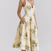 Woman in yellow floral halter midi dress with V-neck