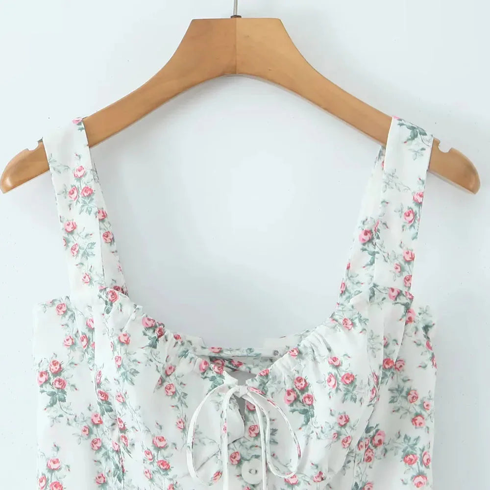 Floral dress on a wooden hanger against a white background
