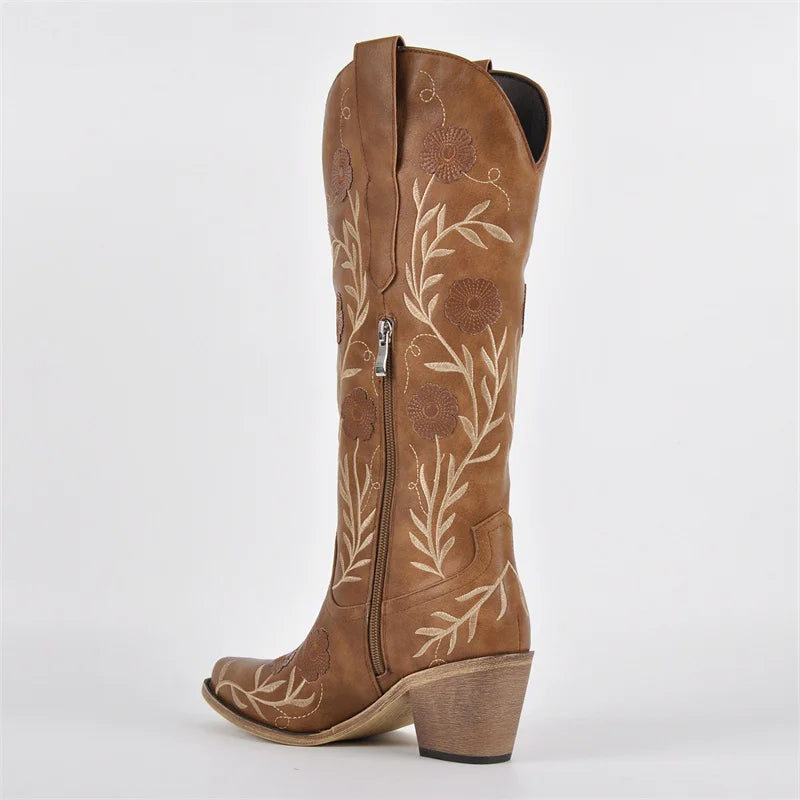 Brown cowboy boot with floral embroidery on a white background