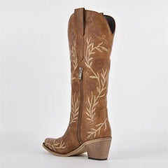 Brown cowboy boot with floral embroidery on a white background