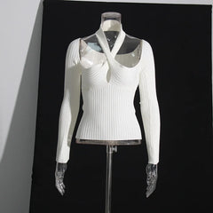 White ribbed sweater on a mannequin against a black background