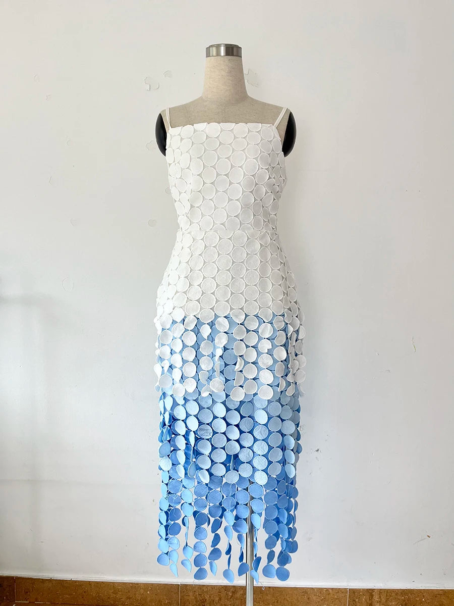 Dress with white top and blue gradient bottom on a mannequin against a white background
