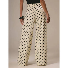 Polka dot pants worn by a person on a neutral background