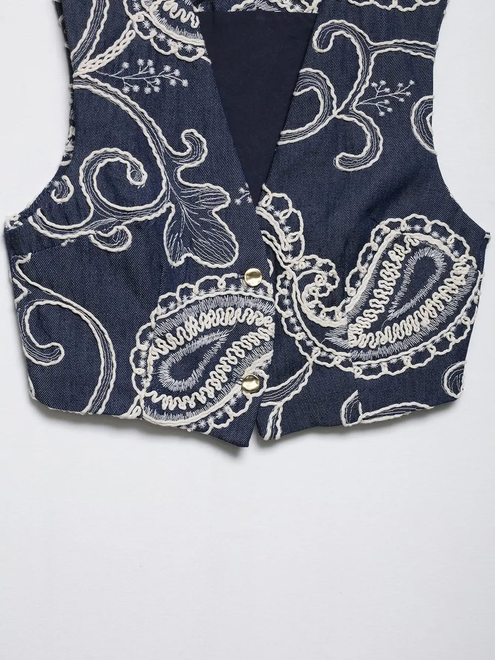 Close-up of paisley print embroidered vest