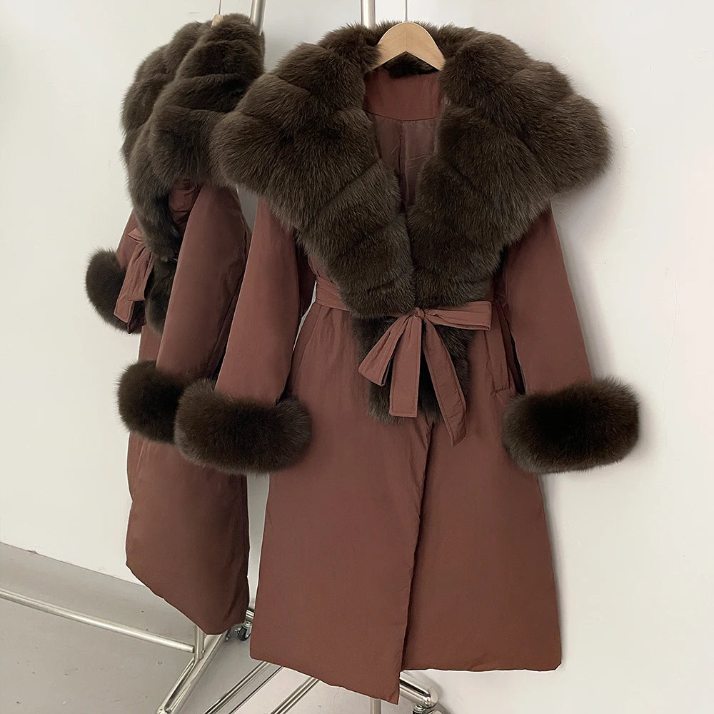 Brown coat with fur trim on a hanger against a white background
