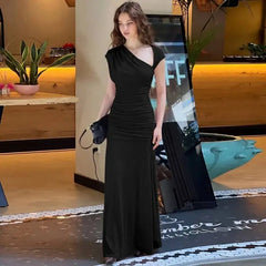 Model in a black ruched maxi dress with one shoulder design