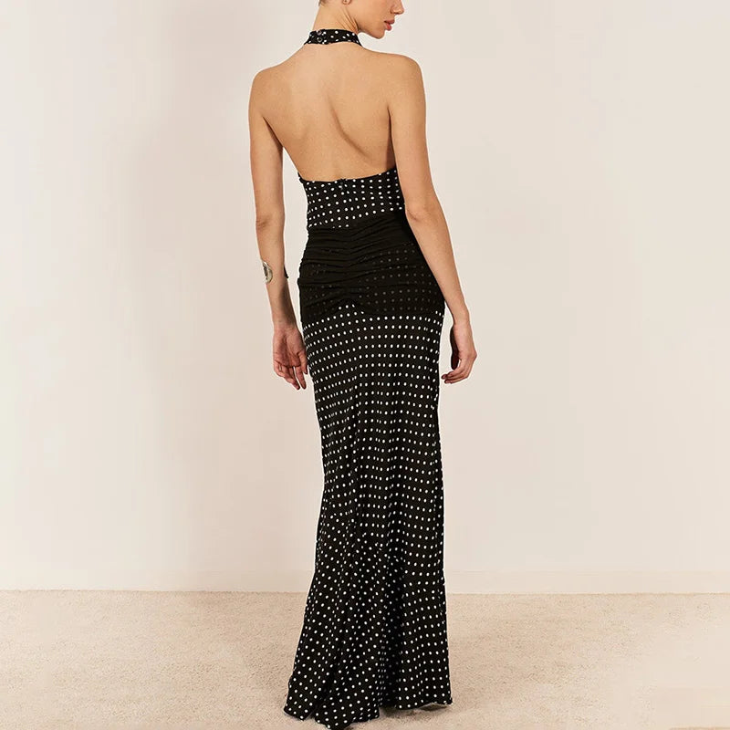 Black evening gown with white polka dots on a beige background