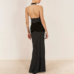 Black evening gown with white polka dots on a beige background