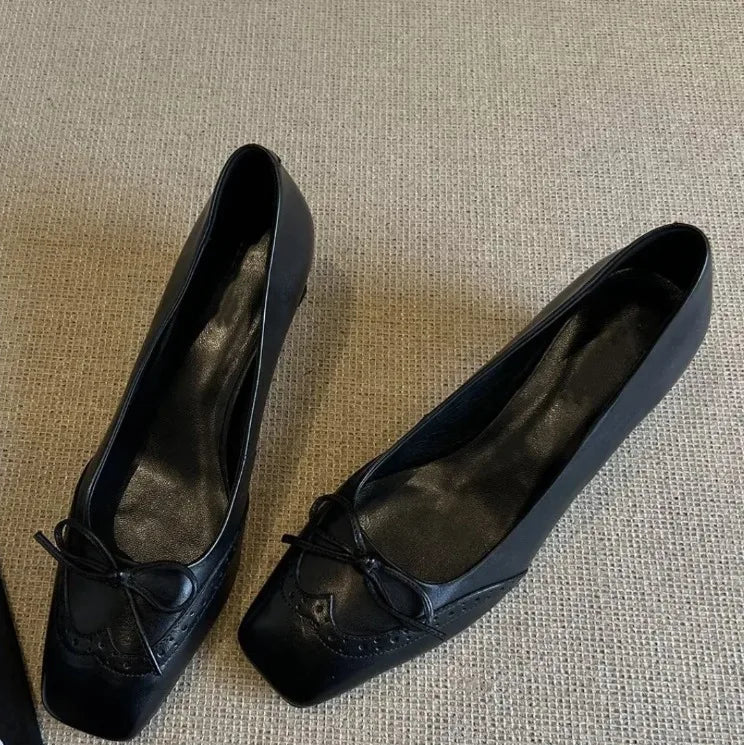 Close-up of the bow detail on a square toe heeled Mary Jane shoe
