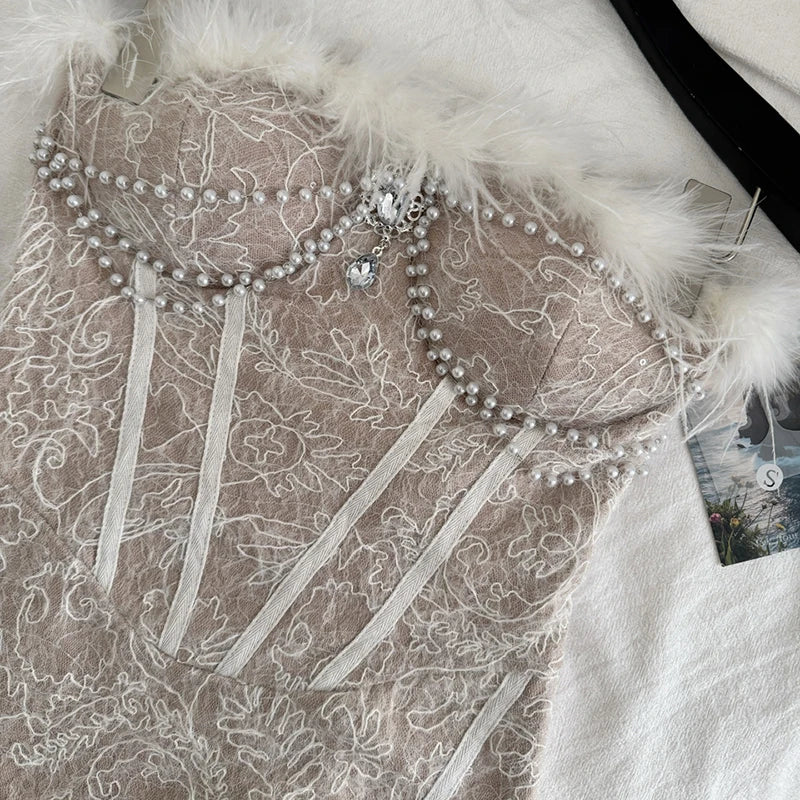 Close-up of feather trim and pearl embellishments on corset dress