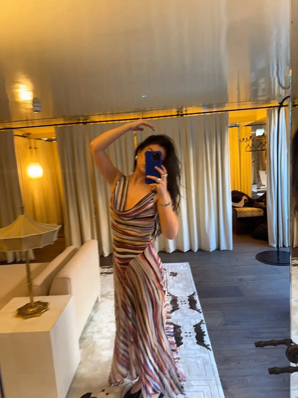 Model posing in a striped V-neck maxi dress