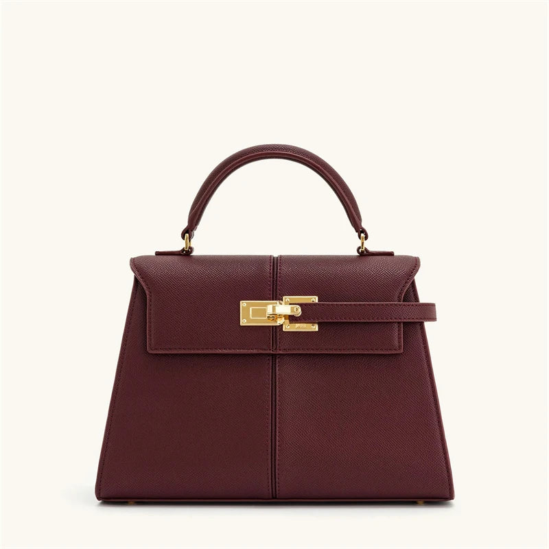 Maroon handbag with gold clasp on a white background