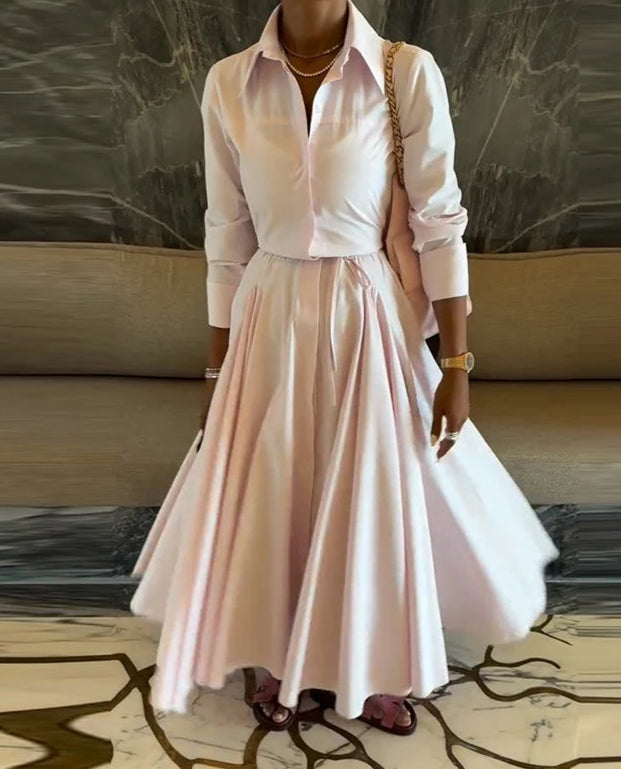 Woman wearing a light pink dress with a marble background