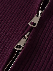 Close-up of a silver zipper on a purple textured fabric background