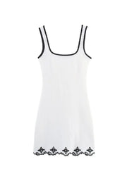 White dress with black lace details on a white background, featuring the brand 'Trafza'.