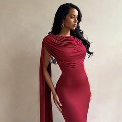 Woman wearing a red dress with a draped effect on a beige background