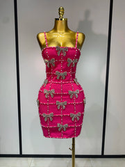Sleeveless beaded bow mini dress on mannequin