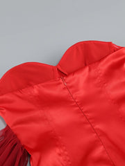 Close-up of a red jacket with fringes on a gray background