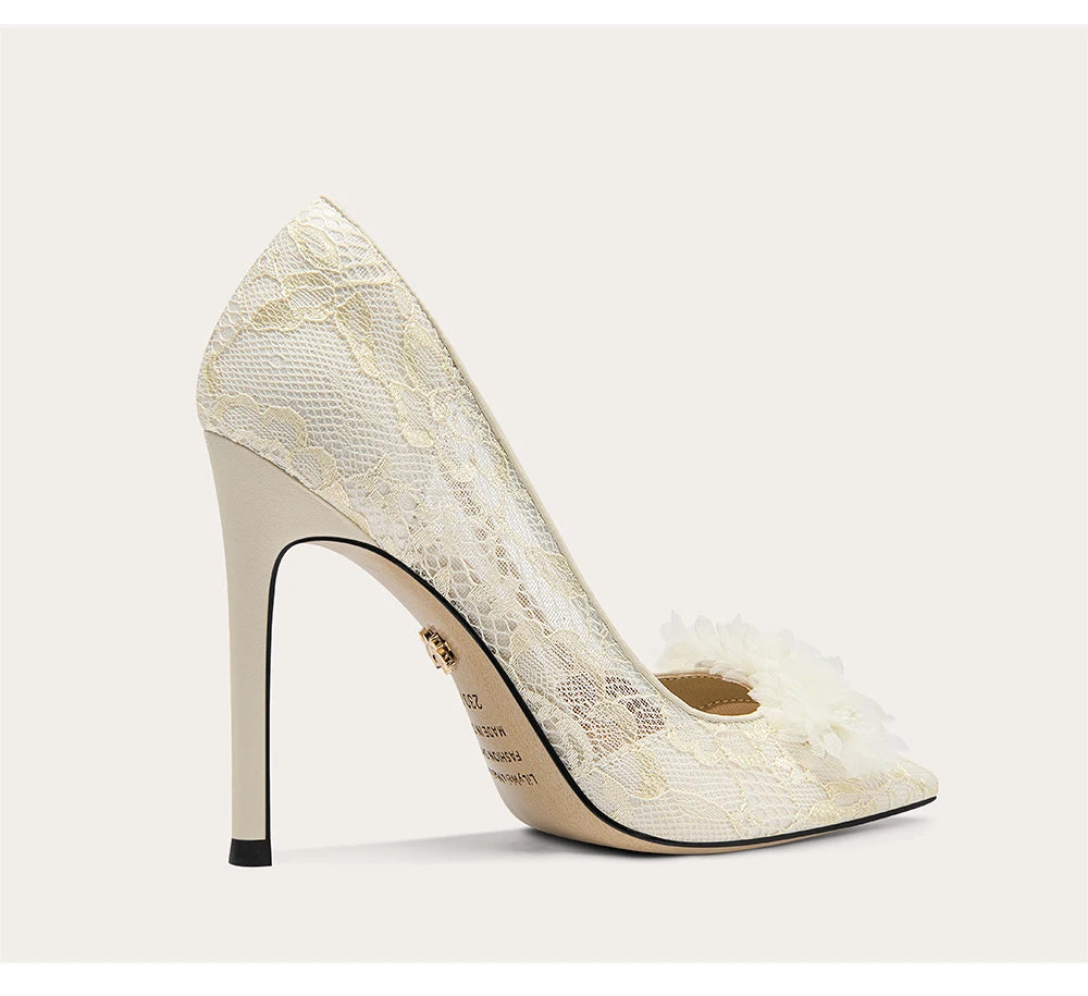 White lace high-heeled shoe on a light gray background