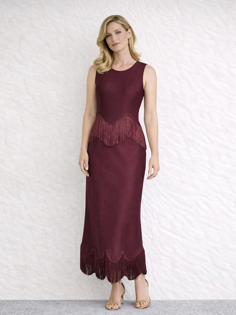 Burgundy sleeveless O-neck maxi dress with fringe trim at the waist and hem.