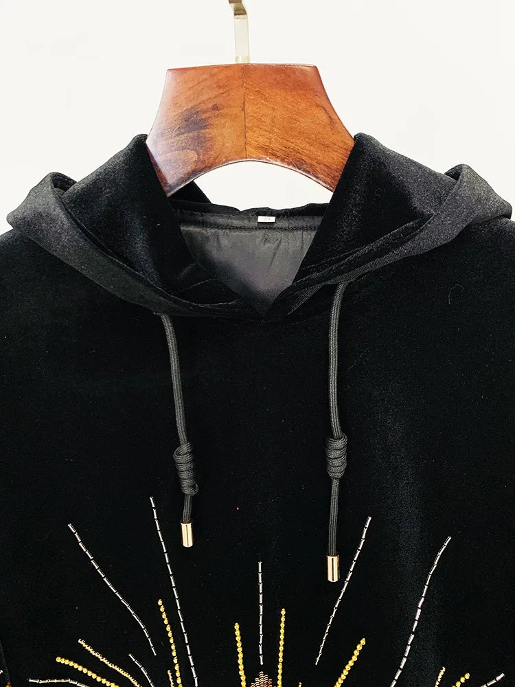 Close-up of the hood and drawstring detail on a black velvet hoodie.