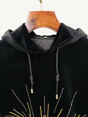 Close-up of the hood and drawstring detail on a black velvet hoodie.