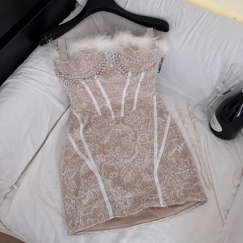 Feather trimmed pearl embellished corset mini dress laid flat