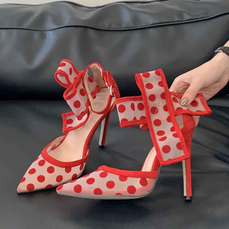 Pair of red and white polka dot mesh heels with large bow