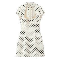 White dress with black polka dots on a white background