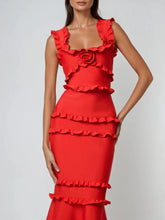 Red ruffled dress on a model against a plain background
