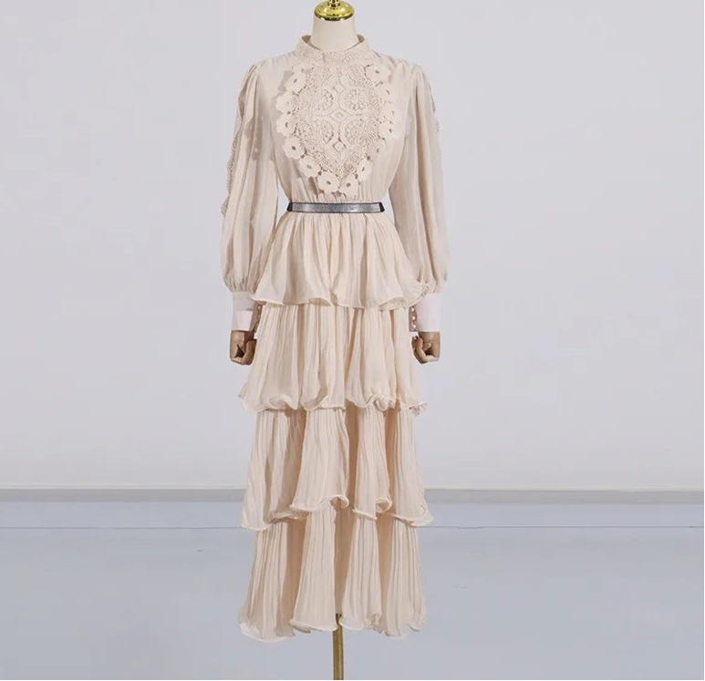 Beige dress with lace detailing on a mannequin against a white background