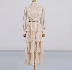 Beige dress with lace detailing on a mannequin against a white background