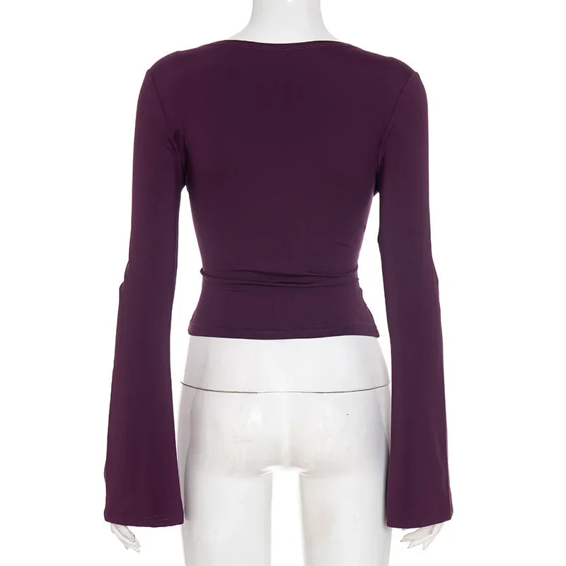 Purple long-sleeve top on a mannequin against a white background