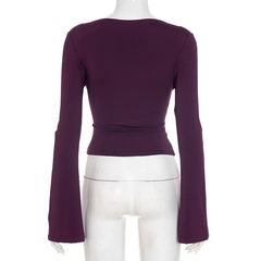 Purple long-sleeve top on a mannequin against a white background