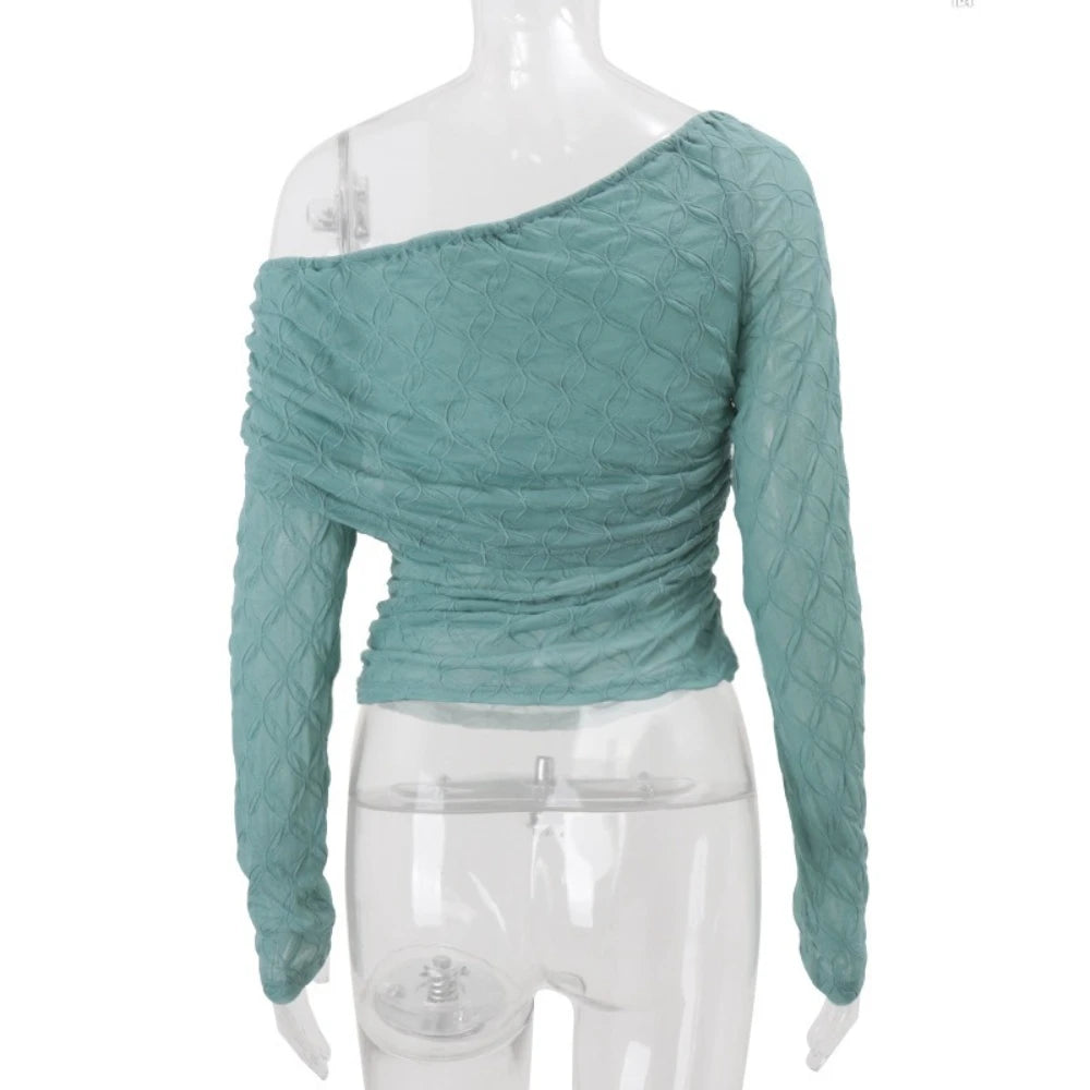 Teal textured long-sleeve top on a mannequin against a white background
