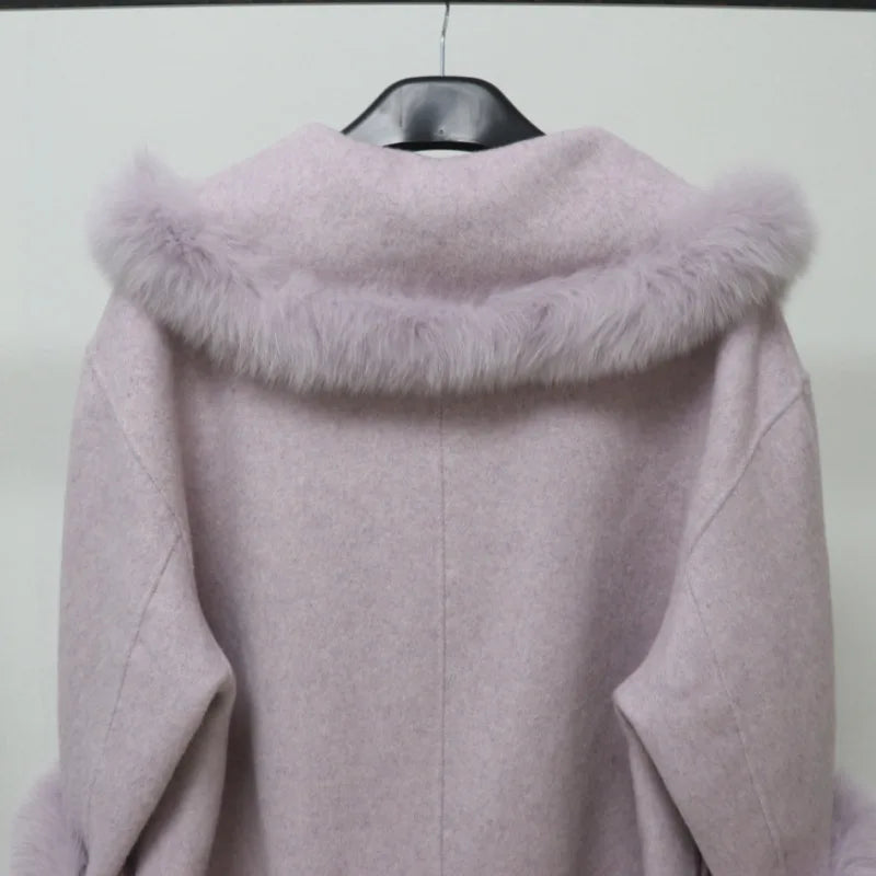 Light purple coat with fur collar on a hanger against a white background