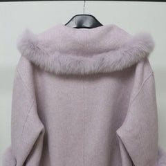 Light purple coat with fur collar on a hanger against a white background