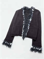 Dark brown cardigan with feather and bead details on a white background