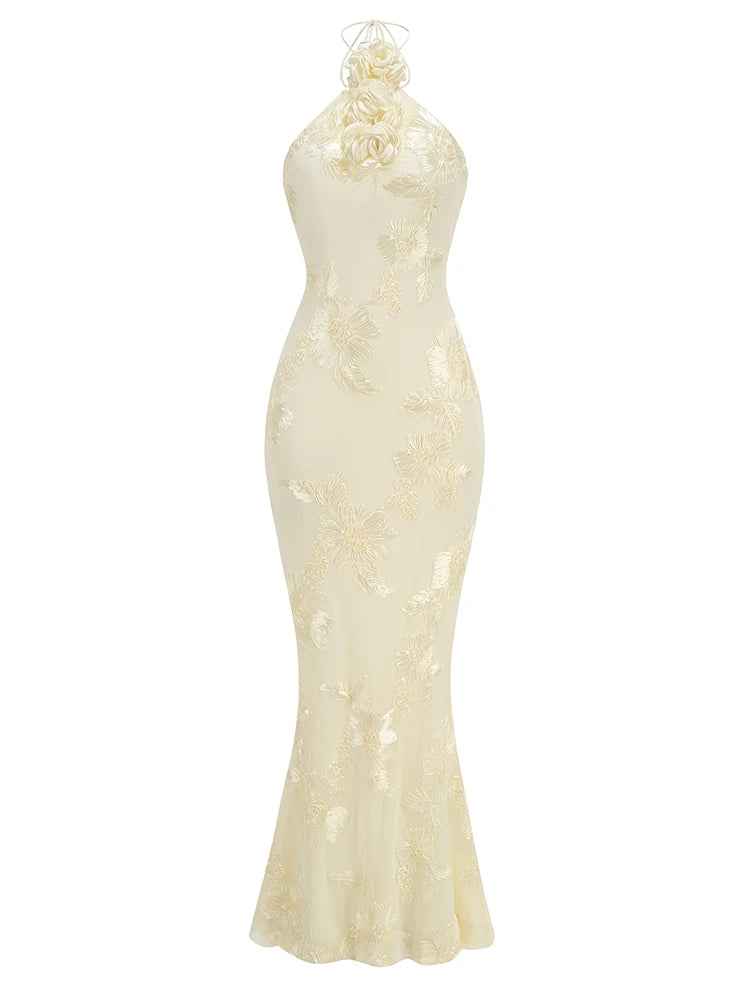Elegant white evening gown with floral details on a white background