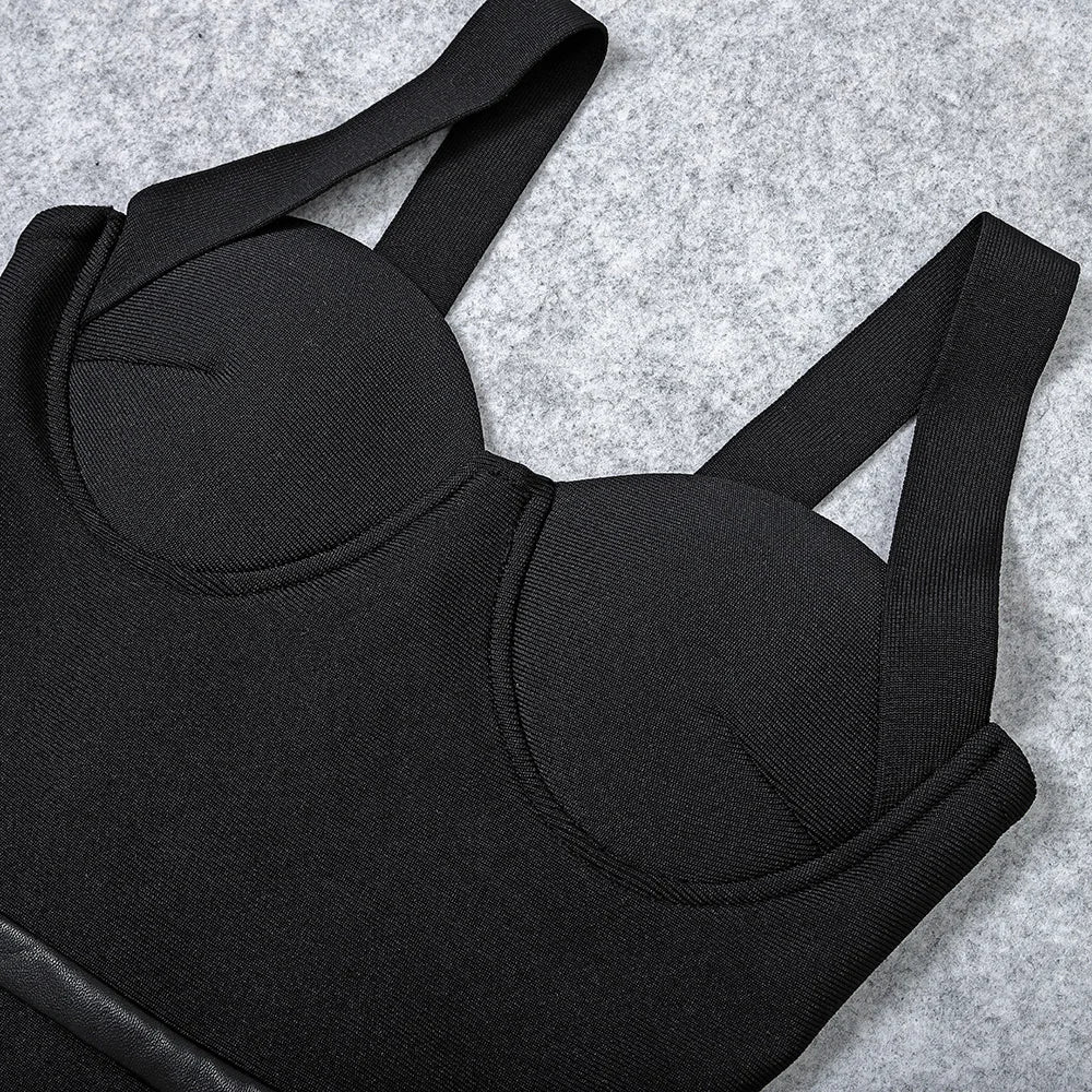 Black bralette with straps on a gray textured background