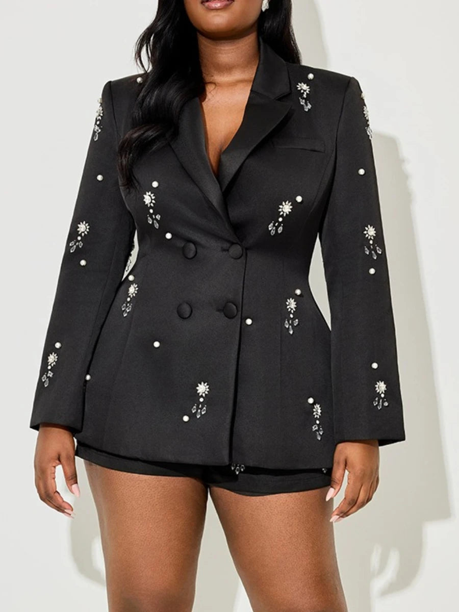 Black blazer with floral embellishments worn by a model on a white background