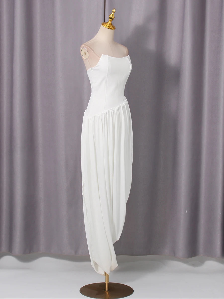 White dress on a mannequin against a gray curtain background