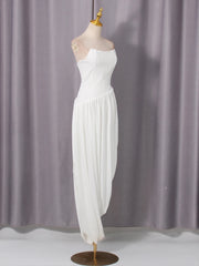 White dress on a mannequin against a gray curtain background