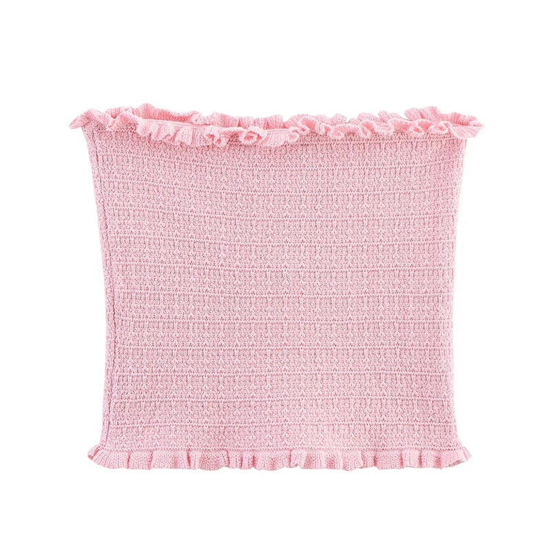 Pink textured fabric with ruffled edges on a white background