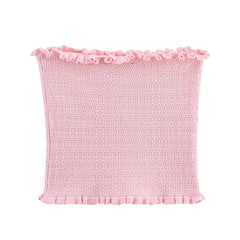 Pink textured fabric with ruffled edges on a white background