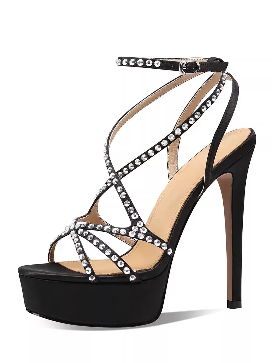 Black high-heeled sandal with studded details on a white background