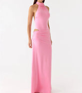 Pink halter neck gown on a white background