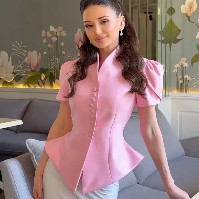 Woman wearing a pink blouse in an indoor setting with decorative elements.