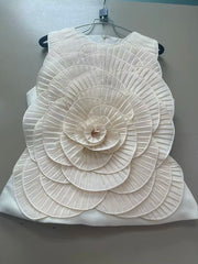 White floral dress on a mannequin against a plain background