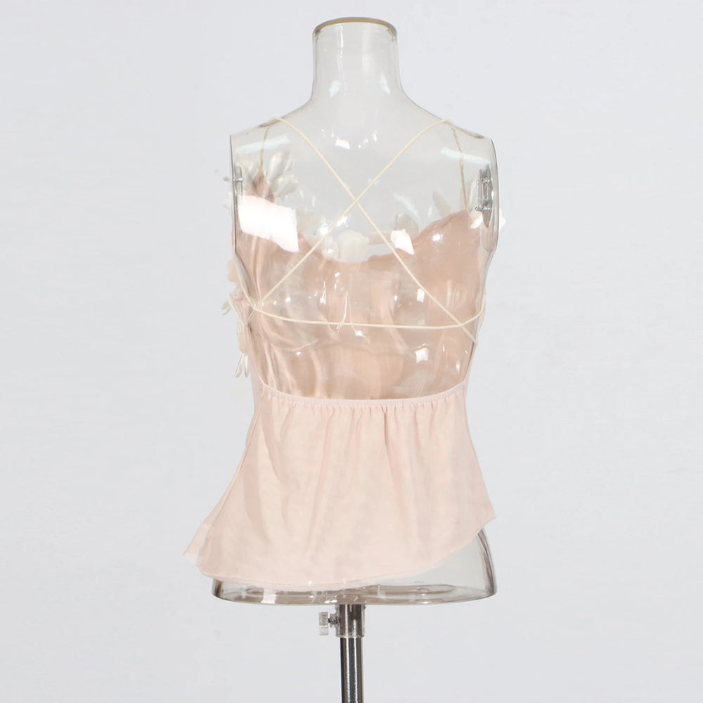 Mannequin wearing a light pink dress with sheer straps on a white background